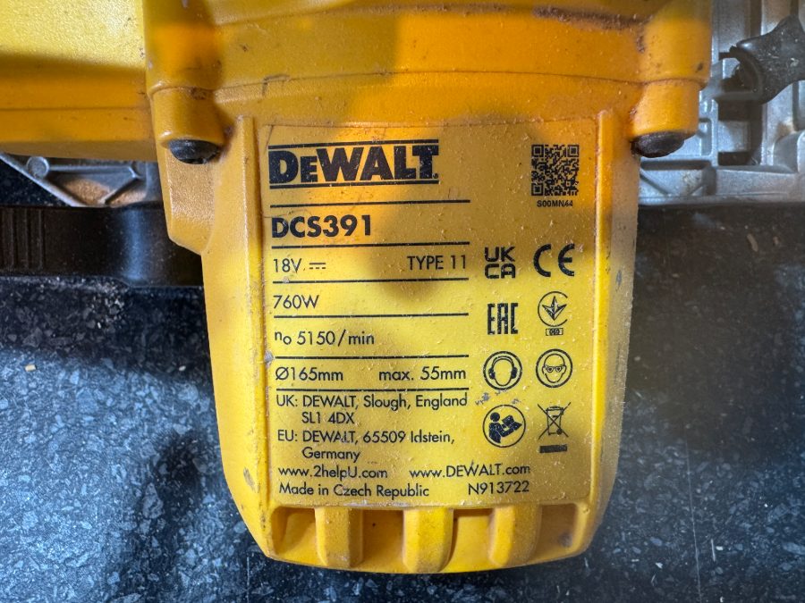 The rating label of the same DeWalt saw, well lit, with the manufacturer, model number (DCS391) and serial number all clearly visible.